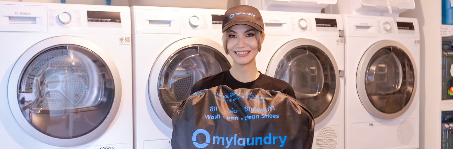 mylaundry staff presenting a laundry bag in our launderette